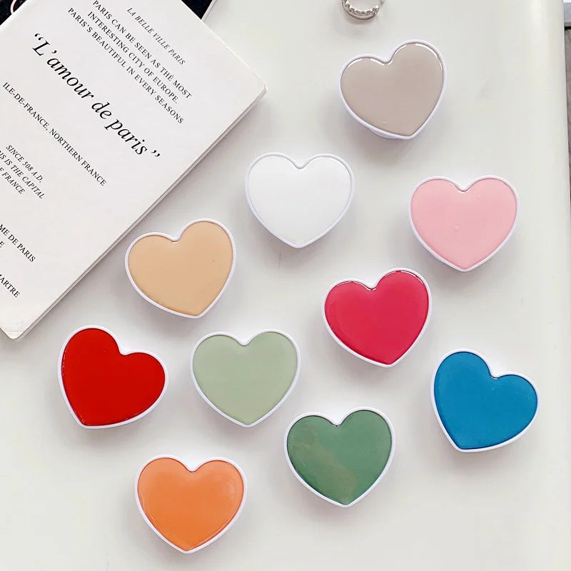 Universal Heart-Shaped Phone Socket Holder: Finger Grip Bracket Support for iPhone 15, 14, 13, Samsung - Pocket Socket Stand